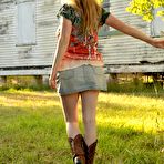 Pic of Trixie in cowboy boots & faded jeans skirt