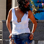 Pic of Raunchy brunette in smooth pantyhose smelling fragrant aroma of her flowers