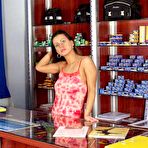 Pic of Busty brunette voyeuristically stripping in store