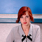 Pic of Red Haired Amateur Teen In Stockings Strip Teasing On A Desk