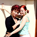 Pic of Horny housewife playing with a lesbian teen on the balcony