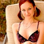 Pic of A horny redhead babe masturbating with a bunch of fruits outdoors
