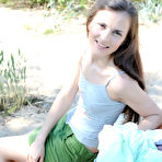 Pic of Long haired teen beauty stripping everywhere vulnerable the sand to show her tits and alluring fur pie