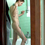 Pic of Hot mature gal in black hose burning with desire looking at stud in shower