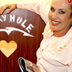 Pic of Mature nanny sucking a black cock through a gloryhole