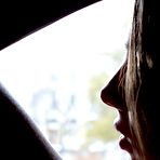 Pic of Young Foxi Di is standing on her knees on leather armchair and opening butt to show exciting holes