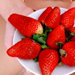 Pic of Naked blonde with shaved pussy Erica B is erotically eating the strawberries
