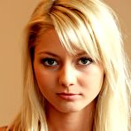 Pic of The seducing blonde Pinky June is lifting her red dress up uncovering view on shaved pussy