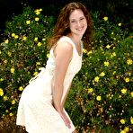 Pic of Curly haired cutie Amber Simpson with small tits and bald pussy strips naked in the sun