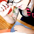 Pic of Inked up four-eyed schoolgirl Dizzee doing her homework and sucking a lollipop