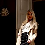 Pic of Elegant blonde Lena Love strips and spread-eagles on a leather sofa in her black holdups