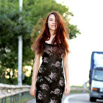 Pic of Cute long haired bombshell undressing and demonstrating naughty quim outdoor in the field.