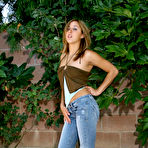 Pic of Shaved pussy chick Jennifer Jade removes her blue jeans and white thong panties outdoors