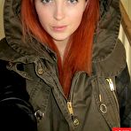 Pic of Sassy Lucy Vixen is taking off her rain coat demonstrating big naked tits underneath