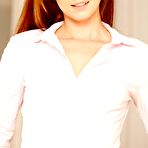 Pic of Redheaded teen in a tight skirt slowly undressing in an empty room - IamXXX.com