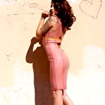 Pic of Kayla Jane with long legs and round ass poses in skin tight rubber dress