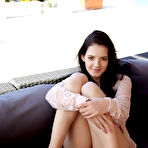 Pic of Dark-haired chick with perky tits spreading the cheeks to show her holes - aMetart.com