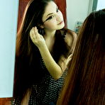 Pic of Curly-haired brunette beauty showing off in a half-filled hot tub - aMetart.com