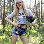 Pic of Stunning blonde babe wearing cute glasses strips naked in the woods and shows us her sweet natural tits. pics