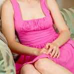 Pic of Nude Xena sensually strips on the sofa baring her pink nipples and pink pussy.