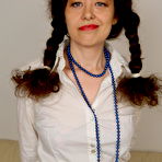 Pic of Horny housewife with pigtails goes crazy on her couch