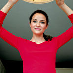 Pic of Blue-eyed brunette in red spreading her legs wide on a round table - aMetart.com