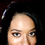 Pic of Latina bimbo Aliana Love smiles playing with cock sticking out of the glory hole