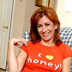 Pic of Mature lady Mikela Kennedy with hairy snatch removes her jeans and red panties