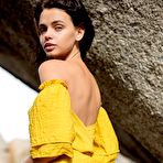 Pic of Brunette beauty Ariel revealing her small tits and ass on big rocks