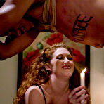 Pic of Long haired naked redhead domina Sabrina Fox playing with obedient Lobo