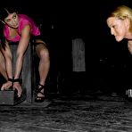 Pic of Blonde Sara Faye and brunette Elyse are bound in the dark of the dungeon.