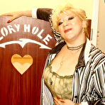 Pic of Big titted cougar takes on a black cock through a hole