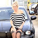 Pic of Frisky blonde Carla Cox flashes by the car in her black stockings and high heels