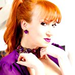 Pic of Red XXX toying on the bed in her purple gown and stockings