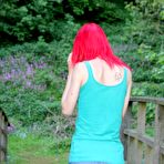 Pic of Slim redhead chick posing in a shirt and skirt outdoors 15 photos