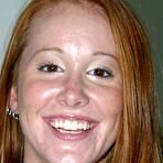 Pic of Amateur chick with long red hair that reaches her tight ass strips naked