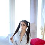 Pic of Young looking girl Tata plays with her long pigtails while baring her hot body