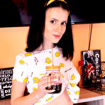 Pic of Charming brunette teen Minnie sips on a drink while getting totally naked