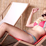 Pic of Blonde girl discards her bikini before toying her pussy on a folding chair