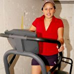 Pic of Latina chick uncovers her big boobs while exercising on a machine