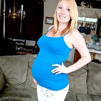 Pic of Blonde girl displays her swollen belly while getting completely naked