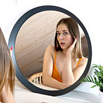 Pic of Sweet teen Muna admires her reflection in a mirror before going nude