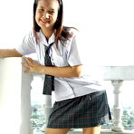 Pic of Asian student shows the pink of her teen pussy on a bed in socks