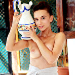 Pic of Brunette teen Gloria Sol pours a pitcher of water over her body in the shower