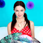 Pic of Beautiful teen Julia holds an oriental fan before getting totally naked