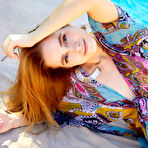 Pic of Teen model Cassia works her nice body free of a robe while next to a pool