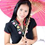 Pic of Busty Thai babe opens her legs wide and slides a sex toy deep inside her cunt