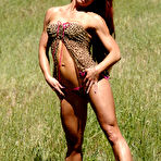 Pic of Bodybuilder with long red hair Tammi Bingham models lingerie in a field