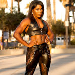 Pic of Black bodybuilder Jaquita Person Taylor flexes outside in black leather attire