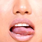Pic of Petite Asian girl licks her lips before showing the pink of her trimmed muff